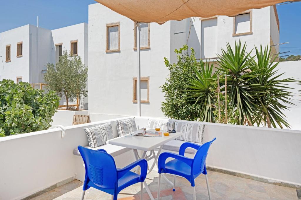 a table and chairs on the balcony of a building at Pico Bello Patmos 14 in Patmos