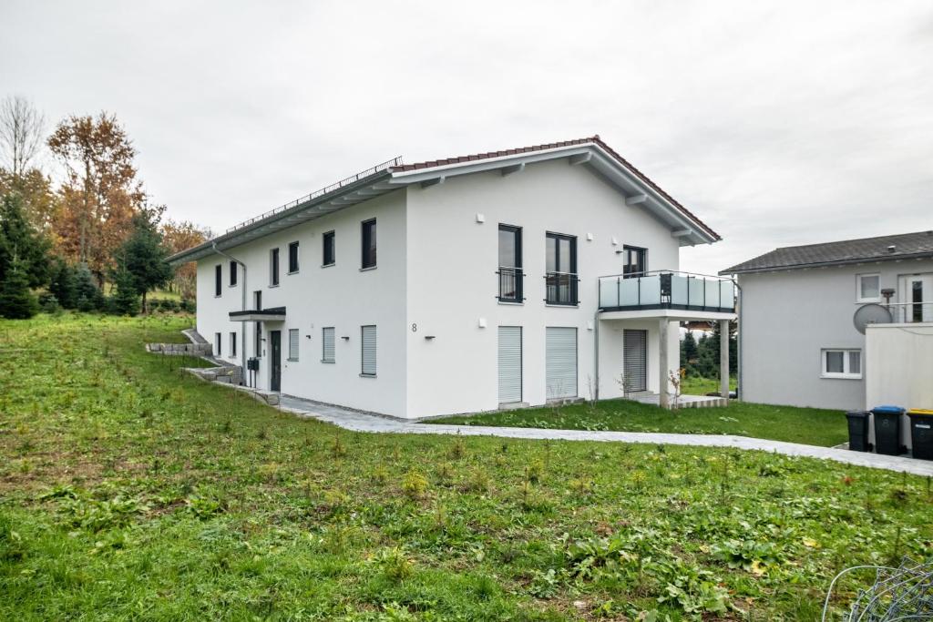 a white house with a green yard at Tanne in Ravensburg