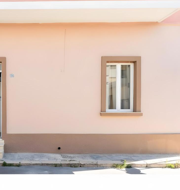 a white building with a window on it at Biancolino Apartments in Nardò