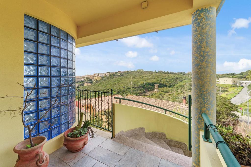 a balcony with a view of a mountain at La Pineta in SantʼAntìoco
