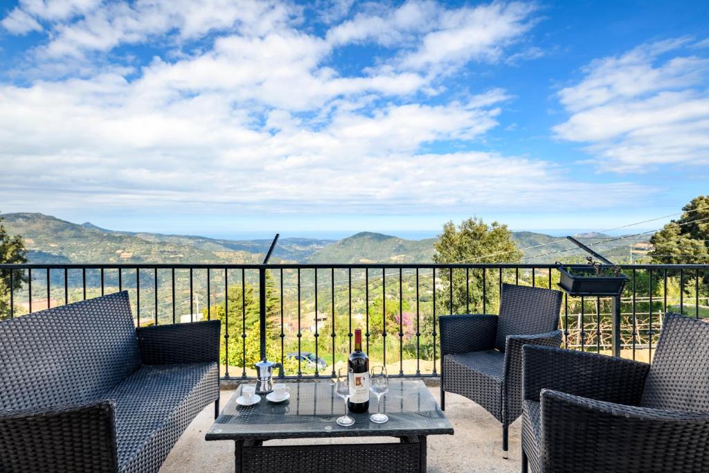 a balcony with chairs and a table with a view at Casa Jerzu S'essia de su santu in Jerzu