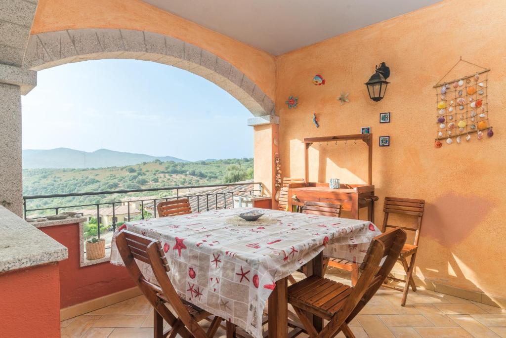 a dining room with a table and chairs on a balcony at Home Residence Barbara in San Teodoro