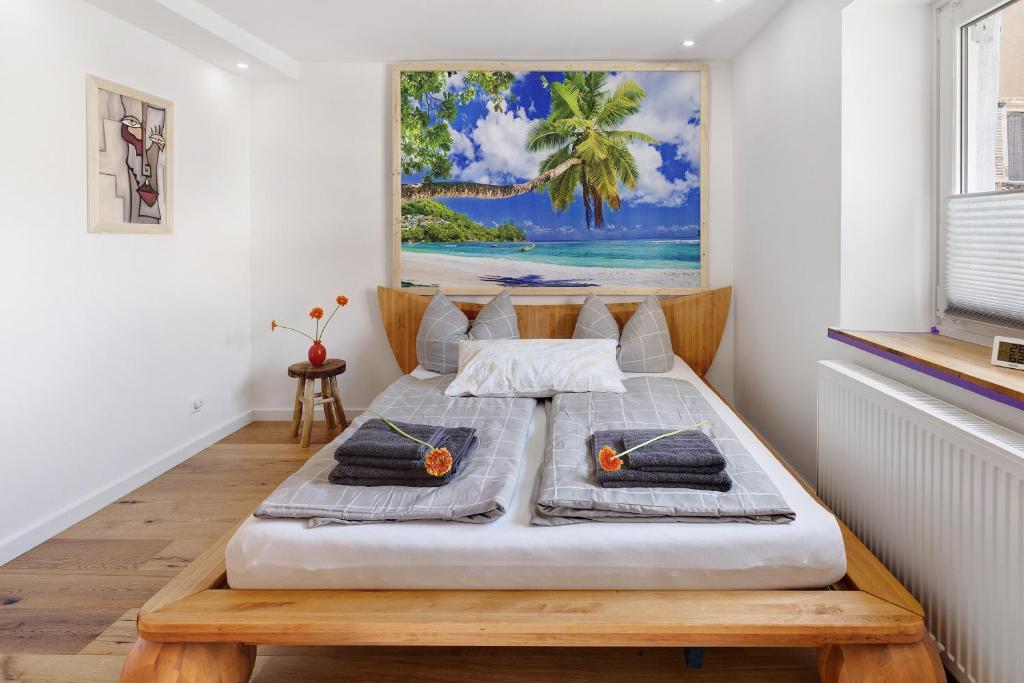 a bed in a room with a painting on the wall at am Hochrhein Desko in Gailingen
