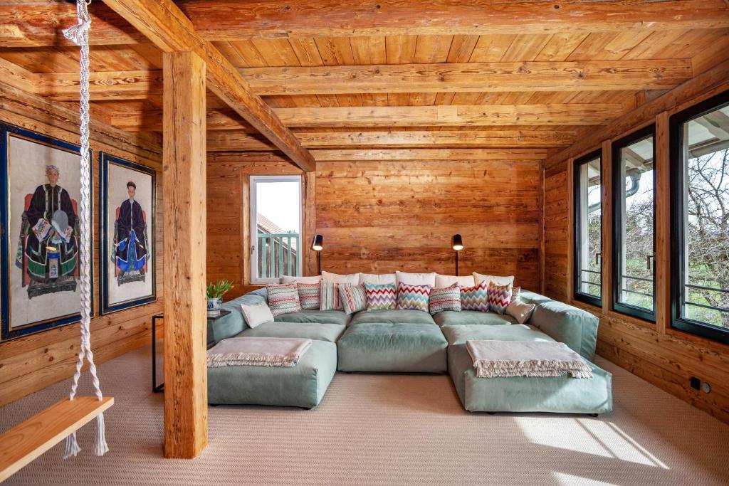 a living room with a large couch and windows at Windhäusern5 in Wangen im Allgäu