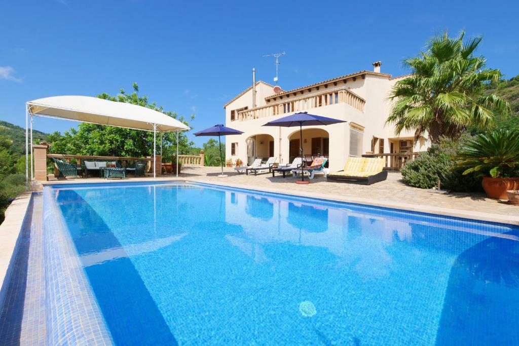 a large swimming pool in front of a house at Cas Cans in Artá