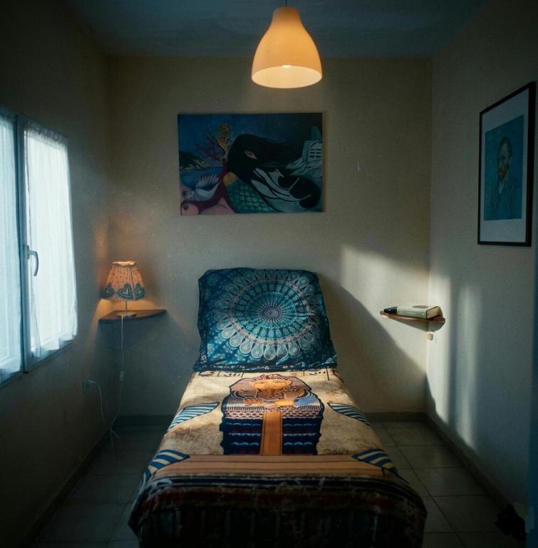 a bedroom with a bed in the corner with a lamp at GTE singola in Poggio