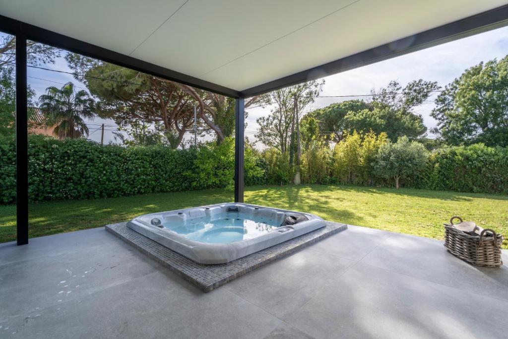 a hot tub on the patio of a house at Villa bord de mer avec piscine in Hyères
