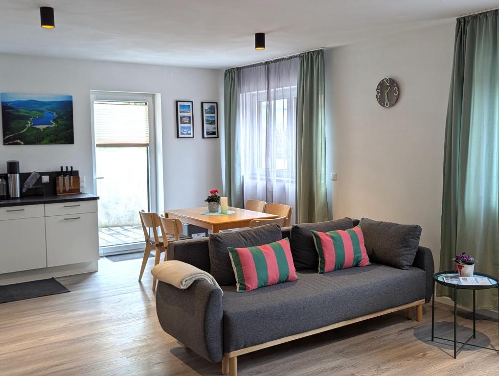a living room with a couch and a table at Schiller´s Urban Escape in Freudenstadt