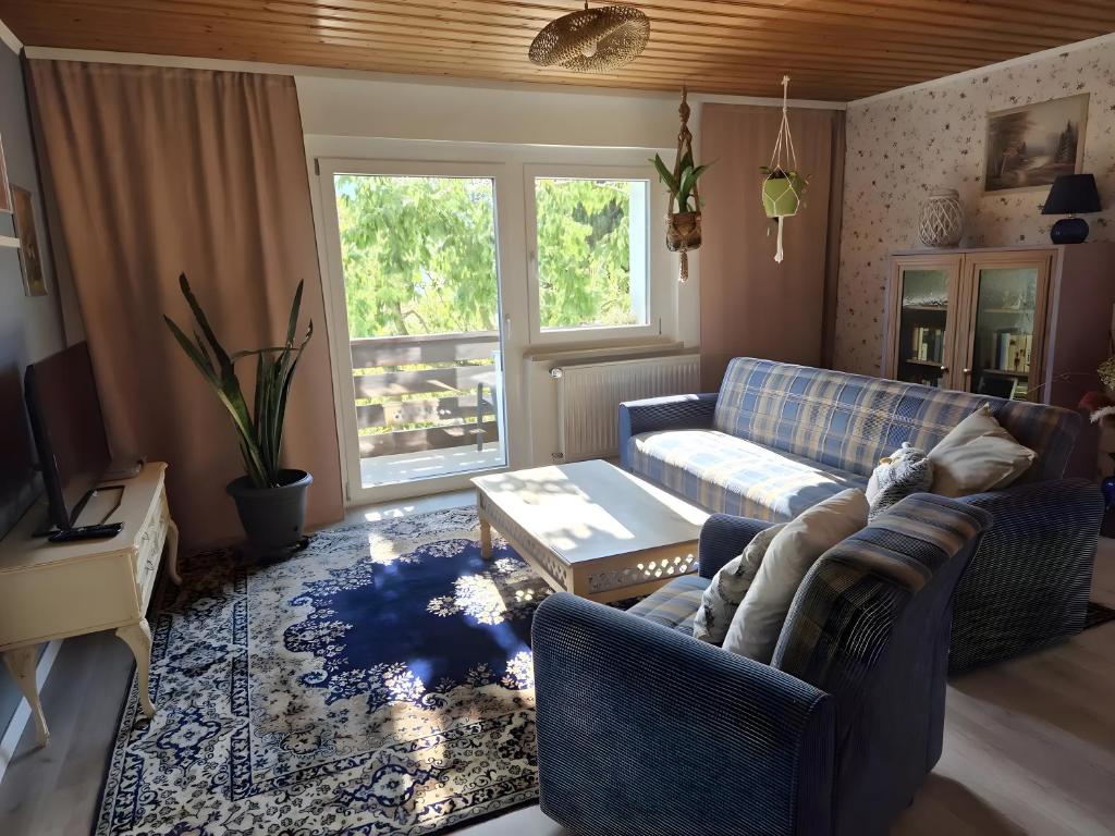 a living room with a couch and a table at Regenhäusl Waldbach in Arrach