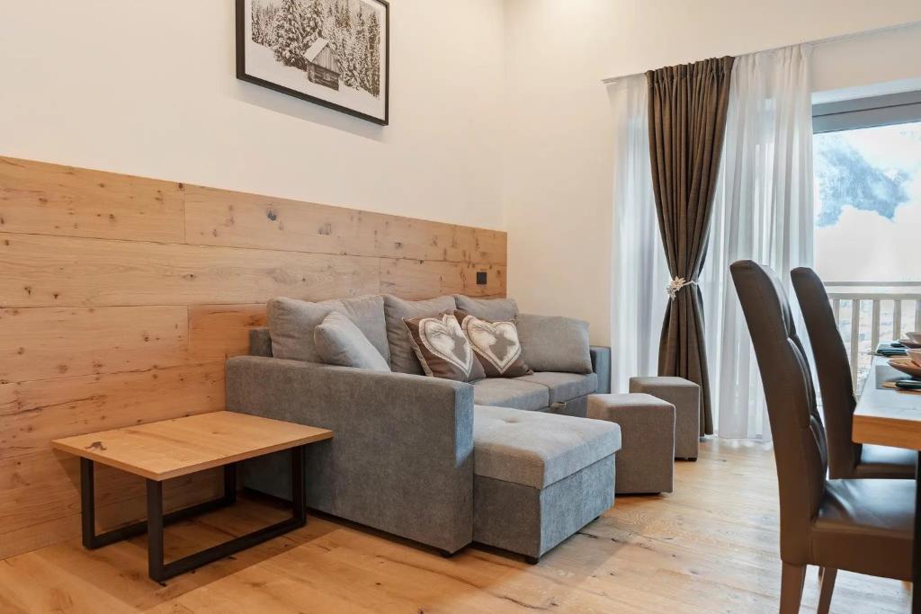 a living room with a couch and a table at Alpen Blumen in San Lorenzo in Banale