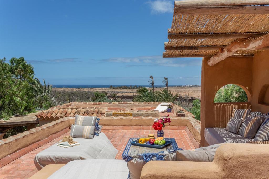 a patio with couches and a table with fruit on it at Oasis San Martin El Cotillo in El Cotillo