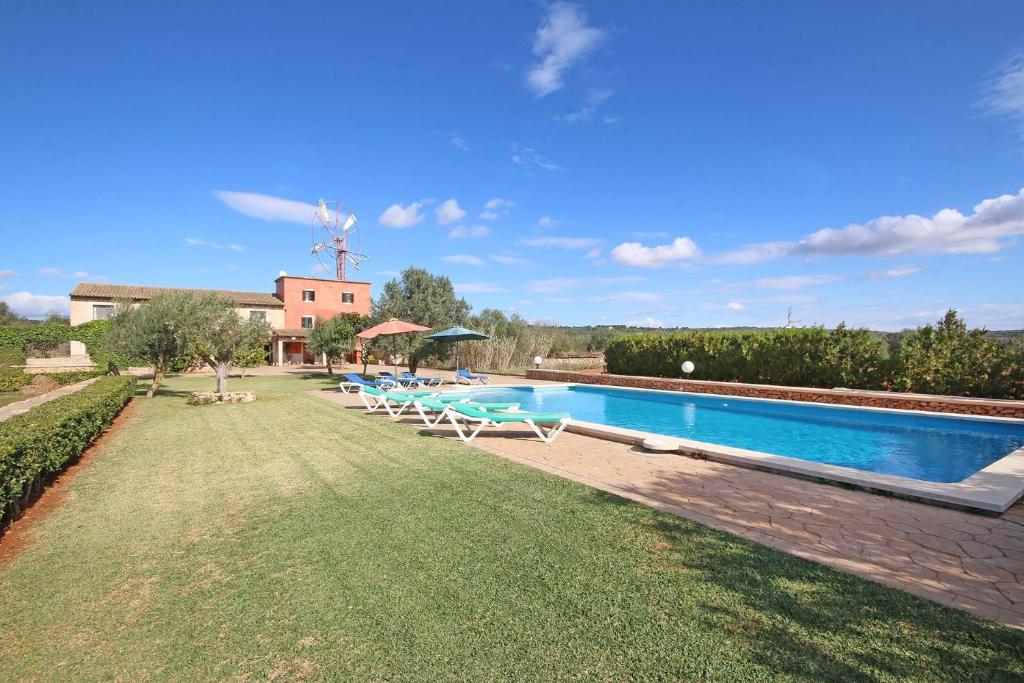 a swimming pool in a yard with a house at S'hort des Cura in Islas Baleares