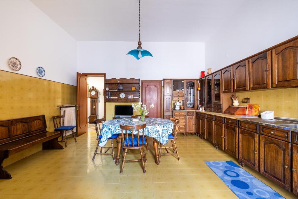 a kitchen with a table and chairs in it at Salento Home in Cursi