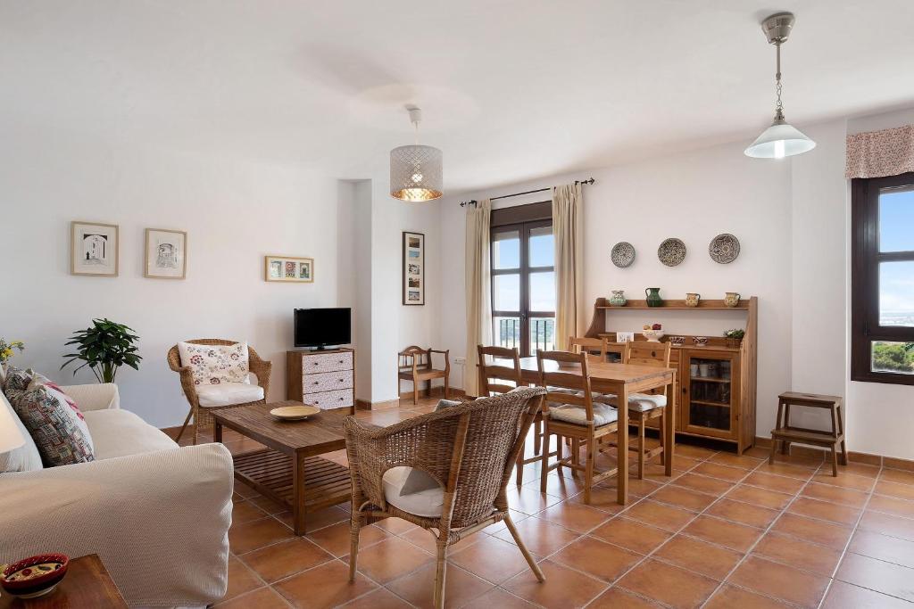 a living room with a table and a dining room at Cobijadas75 Corredera in Vejer de la Frontera