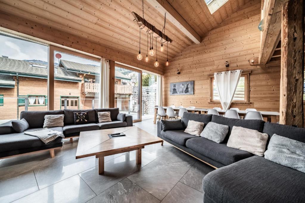 a large living room with couches and a table at Chalet Stéphane centre chatel in Châtel