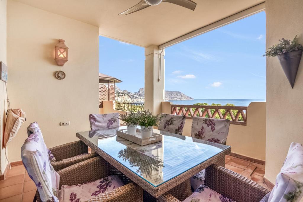 a dining room with a glass table and chairs at Gadea Vistas in Caserío Capnegret