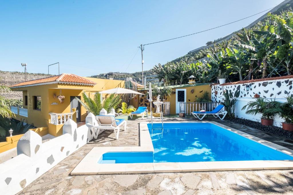a villa with a swimming pool and a house at Finca Alejandrina in La Guancha