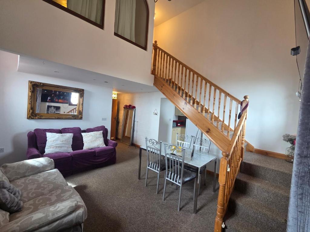 a living room with a staircase and a dining room at Ramsgate Sea-side Stay! in Ramsgate