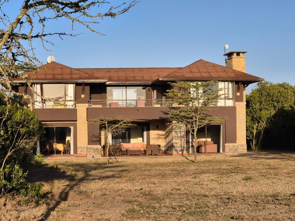 a large house with a yard in front of it at Ol Pejeta Villa in Nanyuki