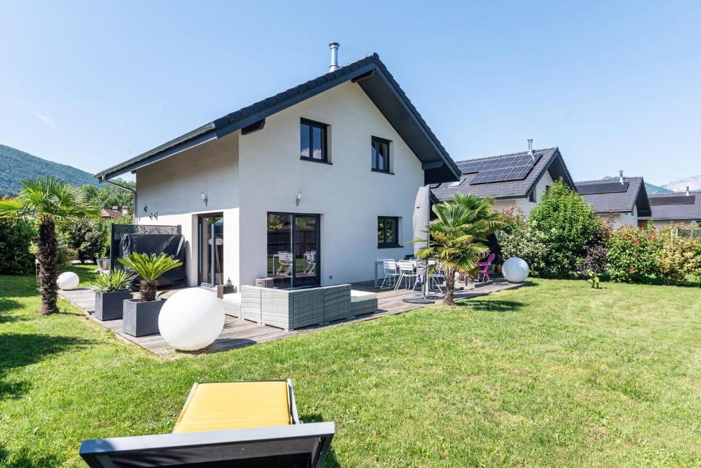 a white house with a lawn in front of it at Maison neuve proche lac d'Annecy in Saint-Jorioz