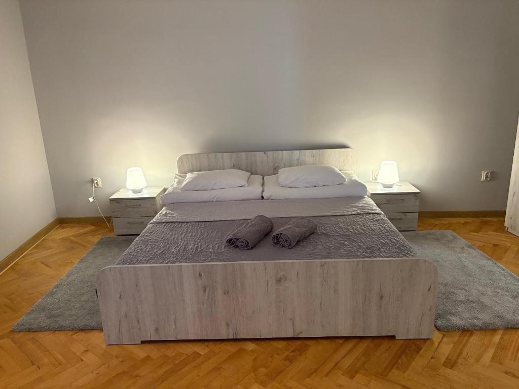 a bedroom with a large bed with two pillows on it at Apartamenty Wałowa 4 in Tarnów