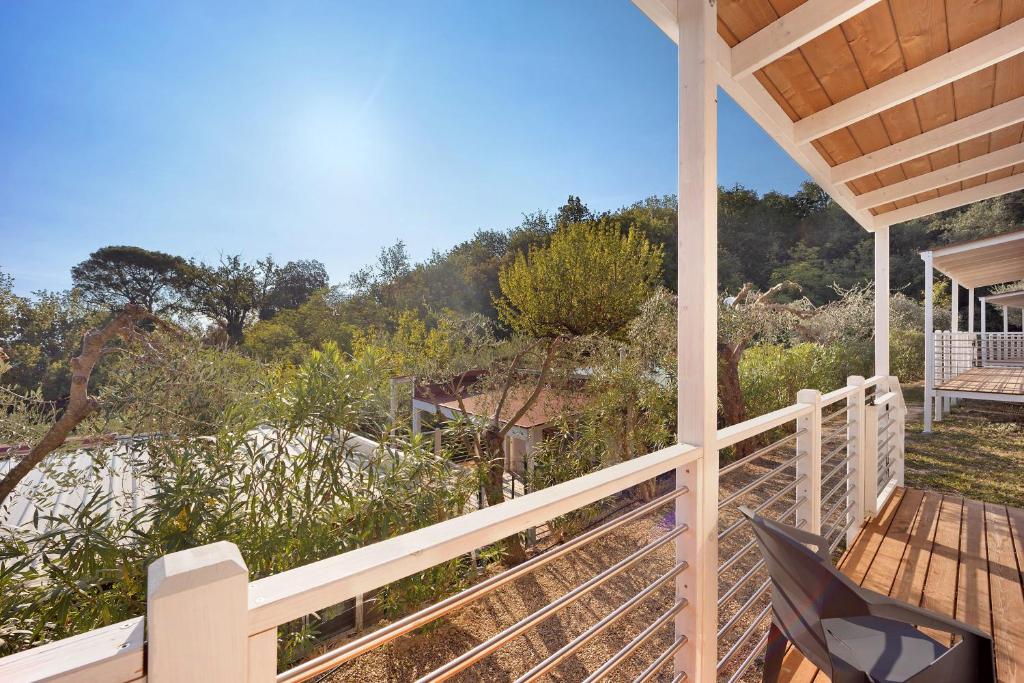 a porch of a house with a view of the beach at Mobile Home Next 229 in Pietra Ligure