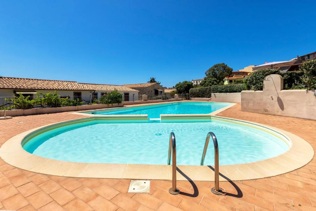 a large swimming pool in the middle of a yard at Casa Nuages in Badesi