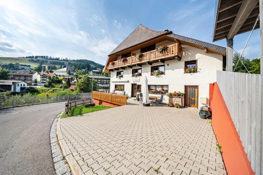 a house with a balcony on the side of a street at Haus Schöneck in Todtnauberg