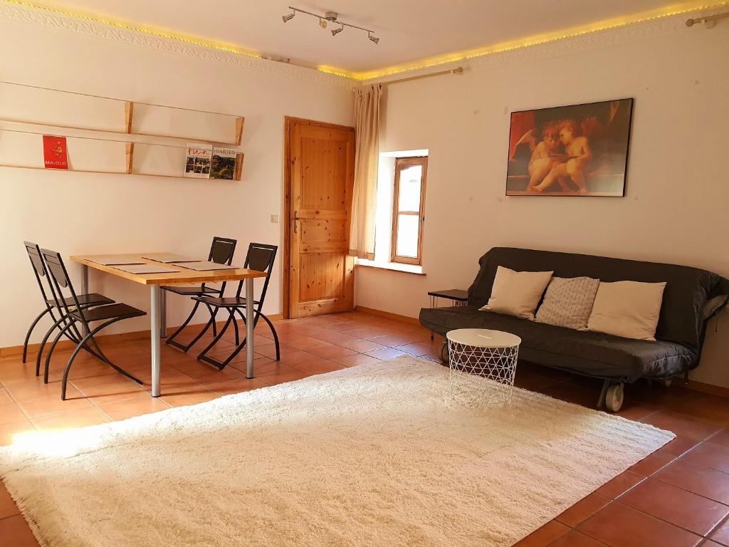 a living room with a couch and a table at Schöne Wohnung Landhaus-Flair in Aachen