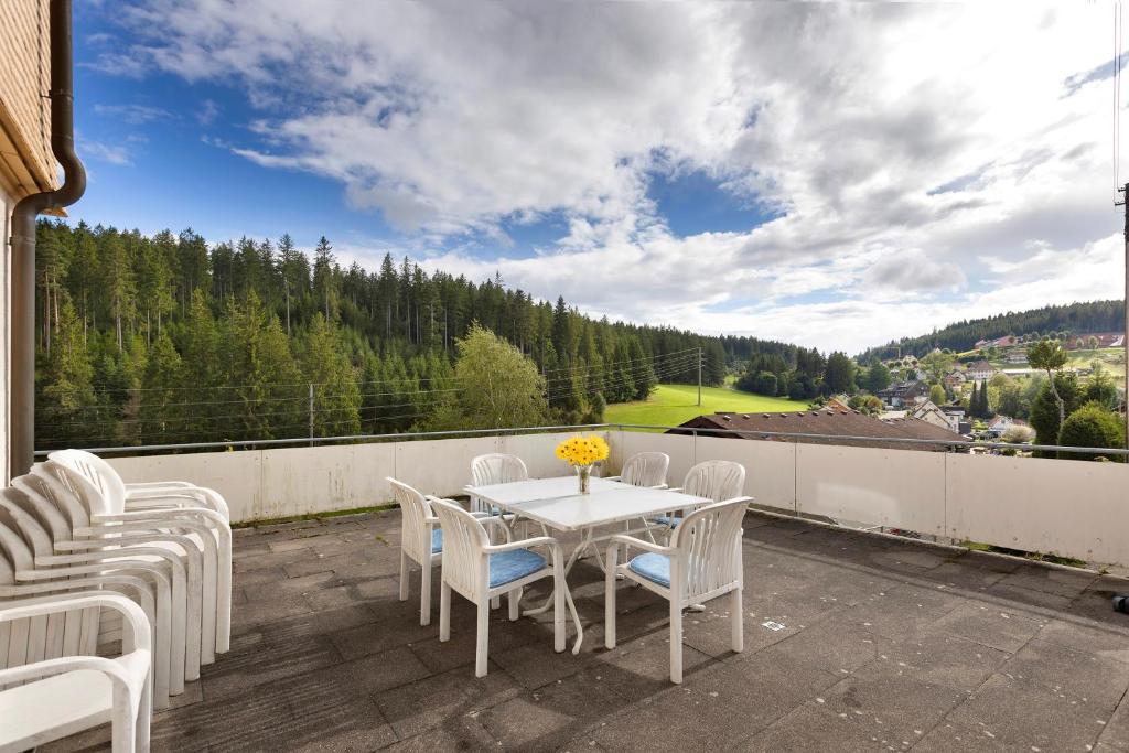 a patio with a table and chairs on a balcony at Ferienheim Eisenbach in Eisenbach