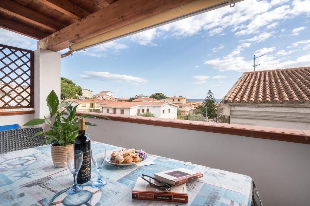 a table with a plate of food on a balcony at Holiday vista mare in Cala Gonone