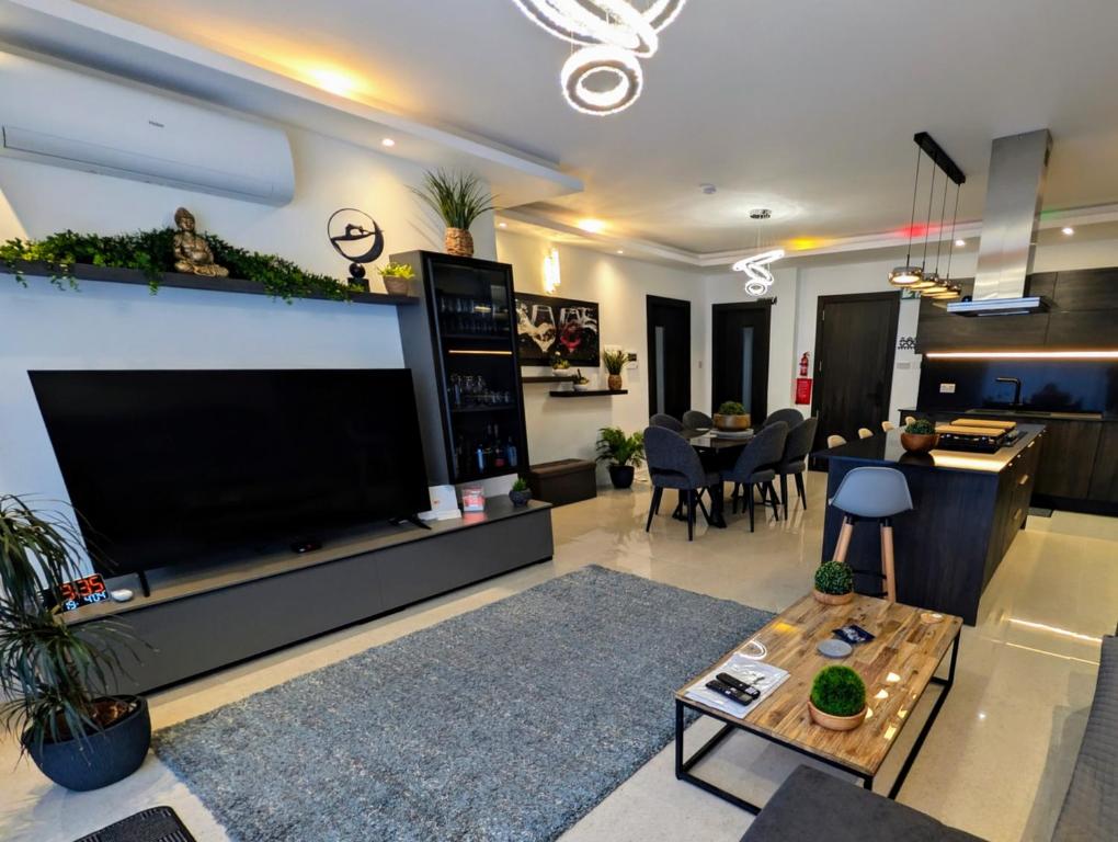 a living room with a large flat screen tv at 19 Oaks in Marsaskala