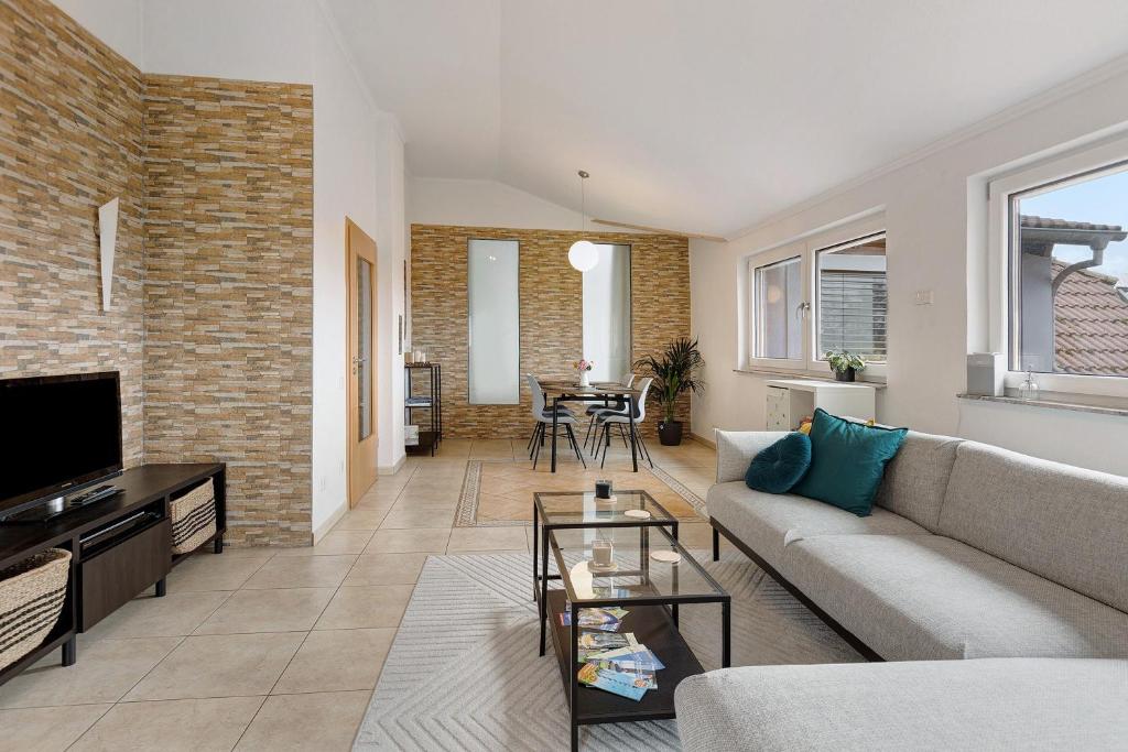 a living room with a couch and a tv at Reif Markelfingen in Radolfzell am Bodensee
