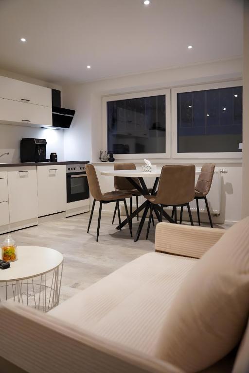 a kitchen and living room with a table and chairs at Ferienwohnung in Pfullendorf