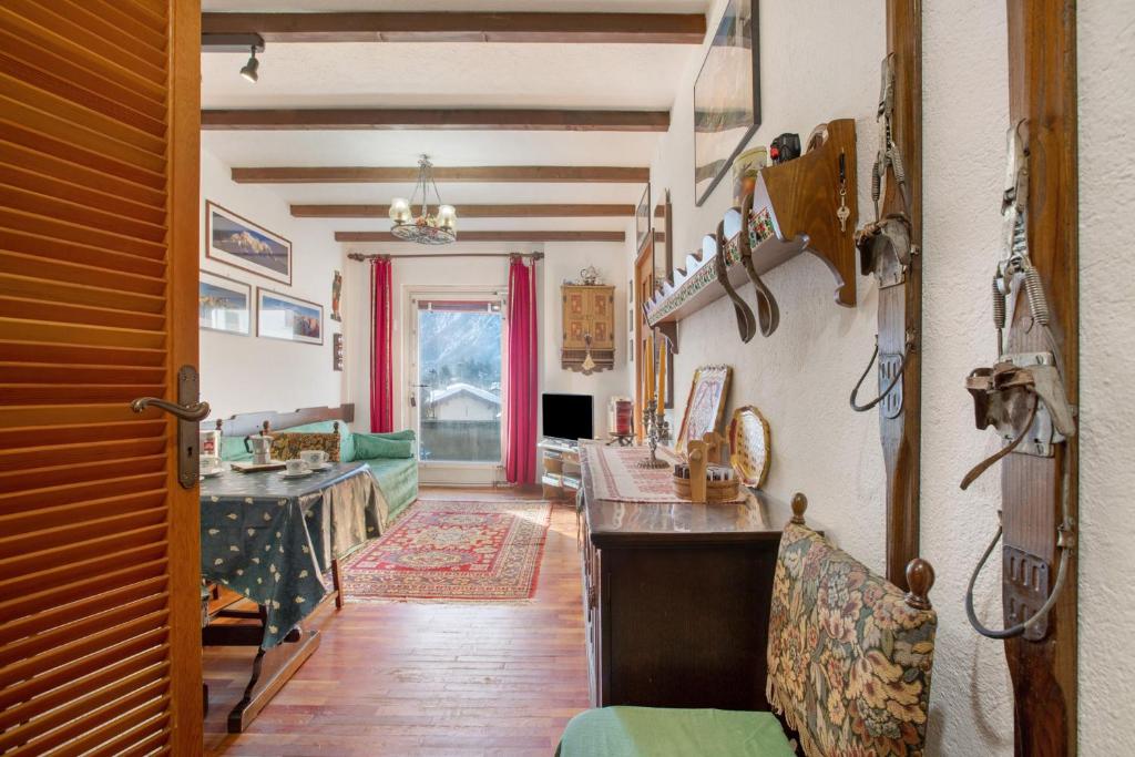 a living room with a table and a couch at Courmayeur 3V21 in Courmayeur