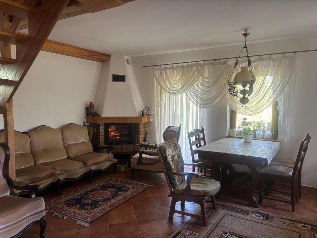 a living room with a couch and a table at Domek wakacyjny in Krzywólka