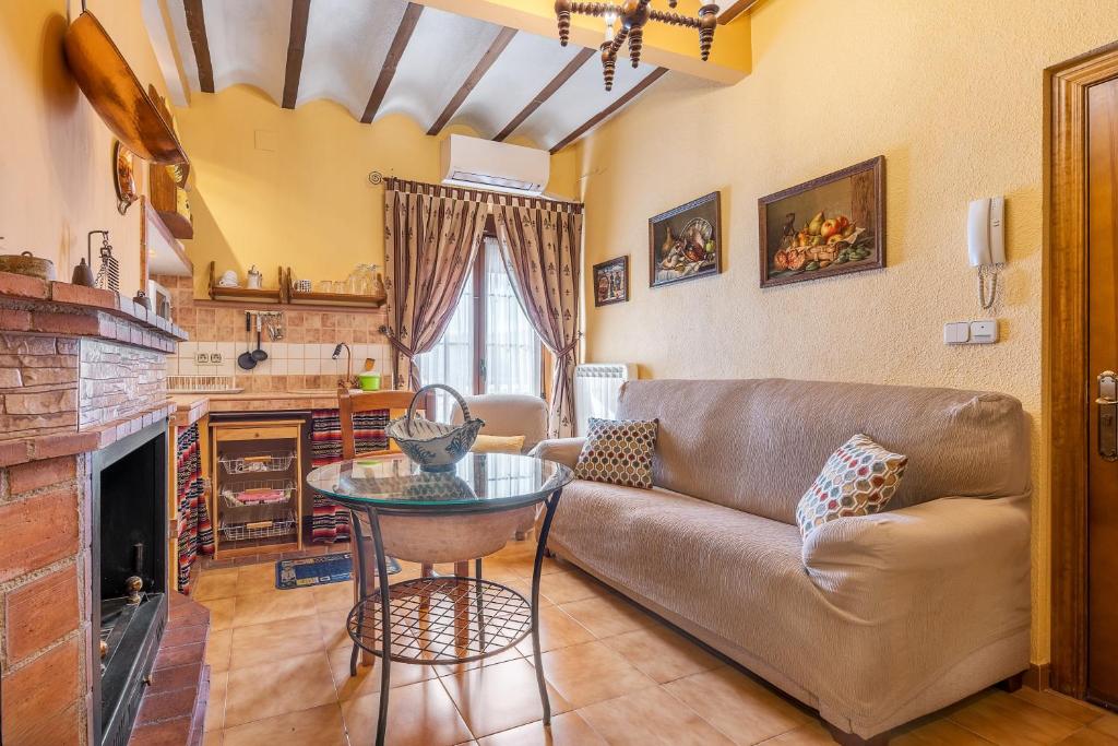 a living room with a couch and a table at Albahaca in Hinojares