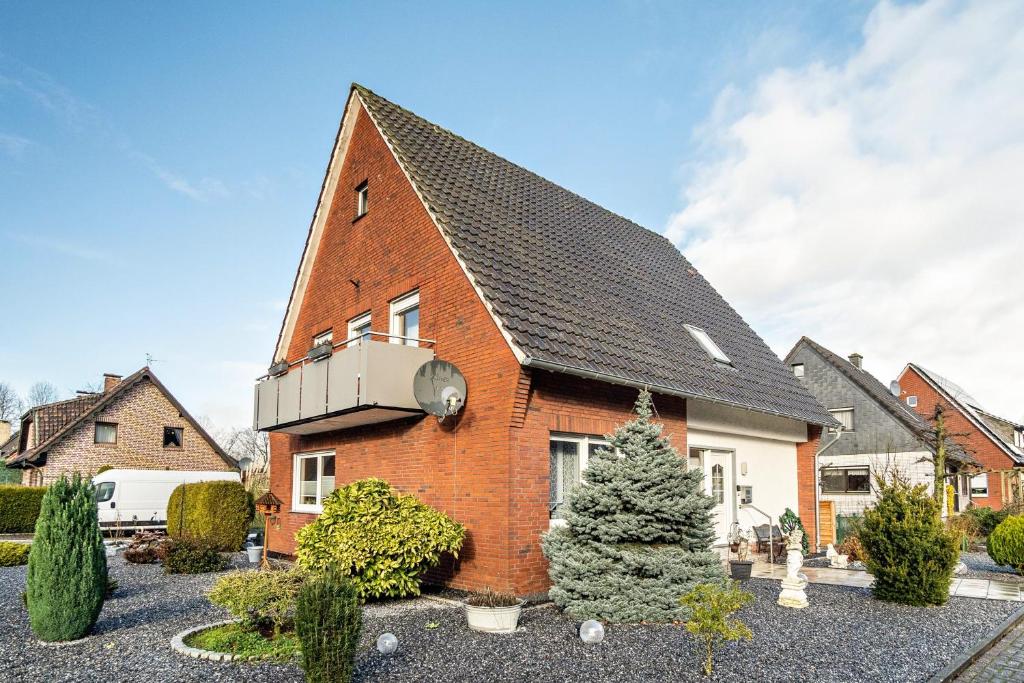 a large brick house with a balcony on it at Münsterland Stadtlohn in Stadtlohn