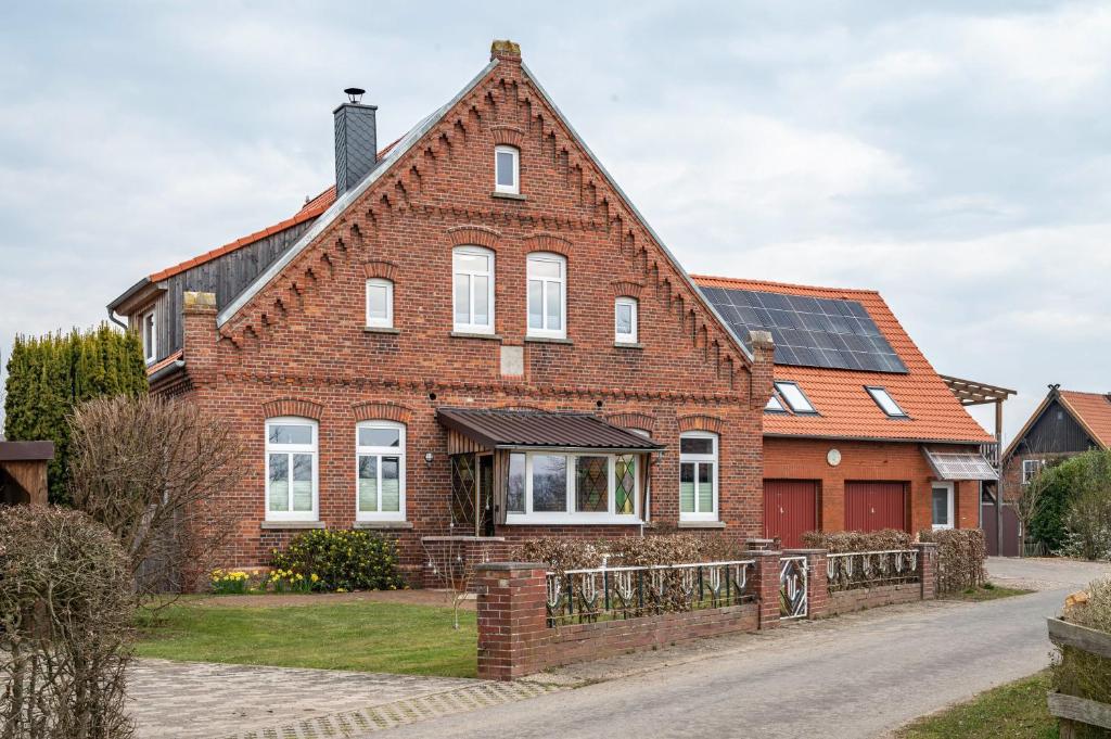 a brick house with solar panels on the roof at Ferienwohnung Dierking in Gilten