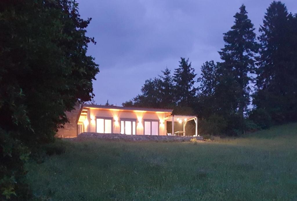 a small house lit up at night in a field at Ferienhaus Summerwiese in Ochsenhausen