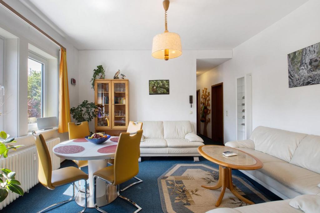 a living room with a couch and a table at Der Falkenhorst in Bad Sachsa