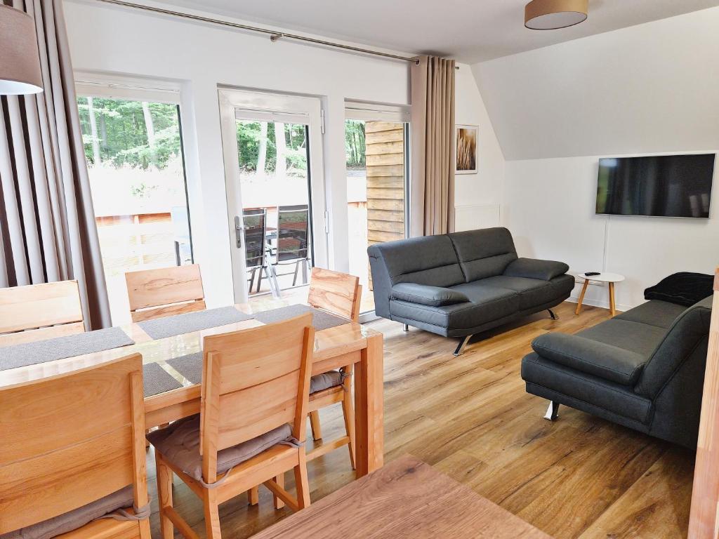 a living room with a table and a couch at Ferienhaus 88 in Bad Arolsen
