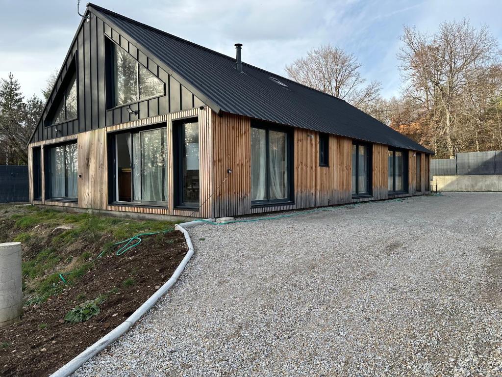 a large wooden building with a lot of windows at Villa julia in Cros