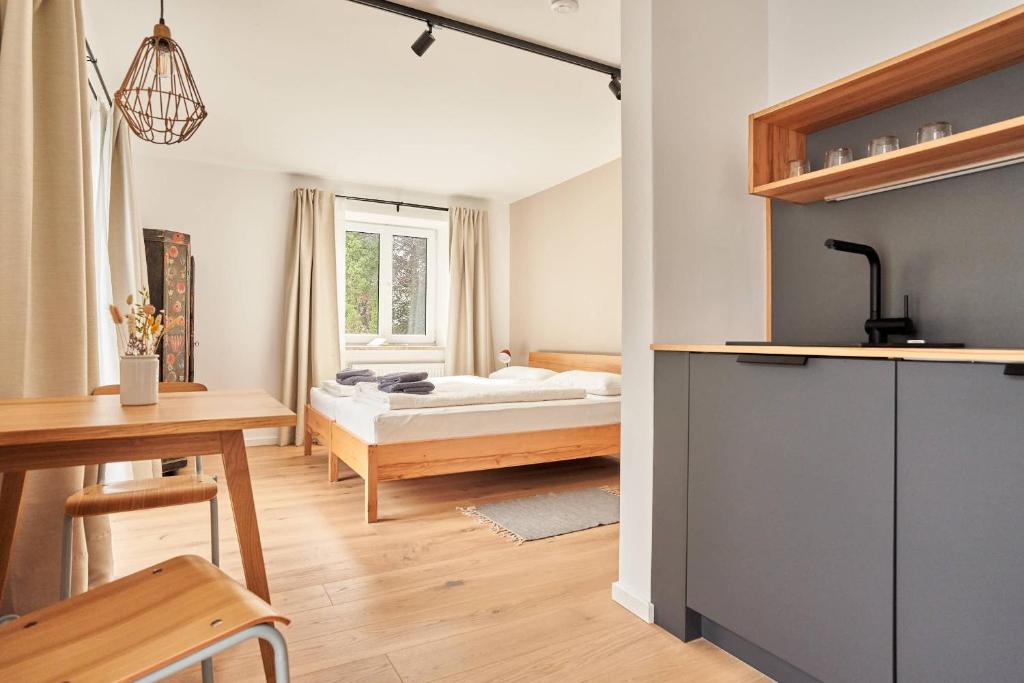 a bedroom with a bed and a desk and a table at Alte Seifensiederei - Viktor in Bad Tölz