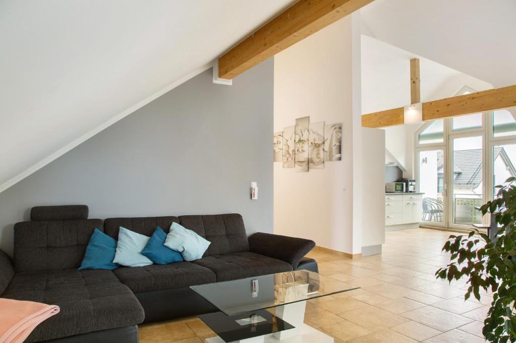 a living room with a couch and a glass table at Christines Ferienwohnung in Eitting