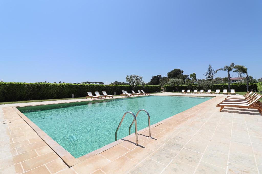 a swimming pool with lounge chairs in a resort at Casa Vacanza Monte Pulciano Otranto in Otranto