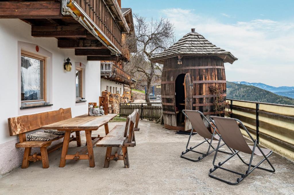 a wooden table and chairs on a patio at Stöcklhuberhof in Vandoies