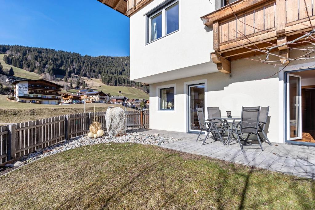 a patio with a table and chairs on a house at Bergschatz in Wildschönau