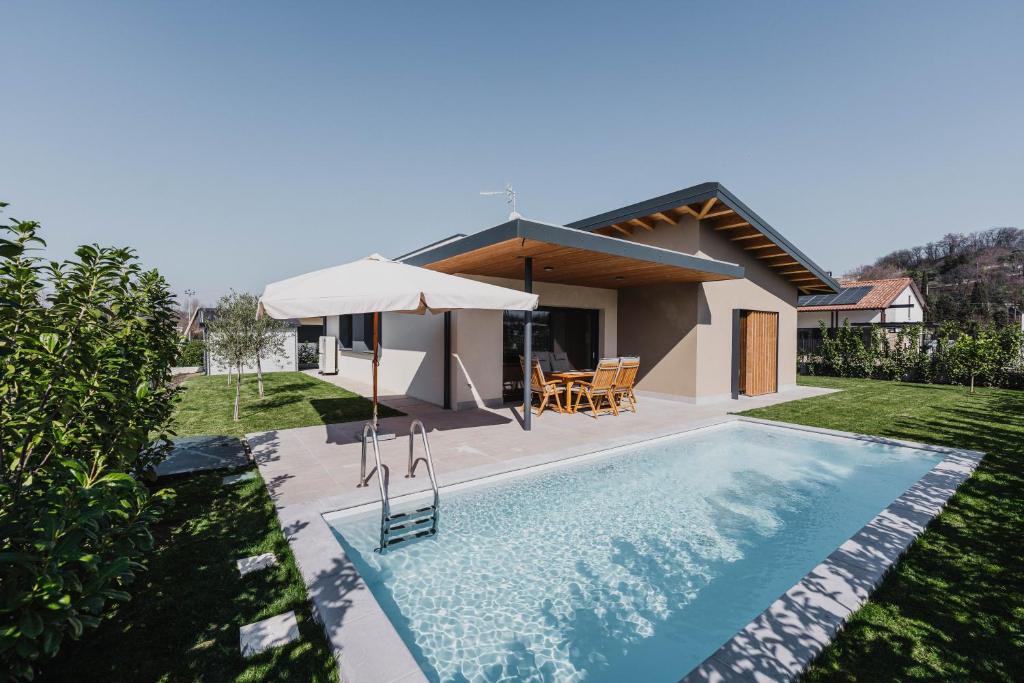 a villa with a swimming pool and a house at Luxe Villa Maxime in Lazise