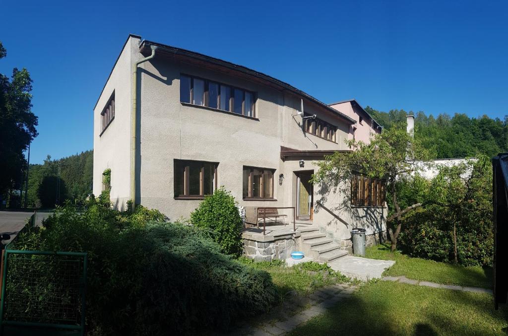a large white house with stairs and windows at Ubytování Líšný in Líšný